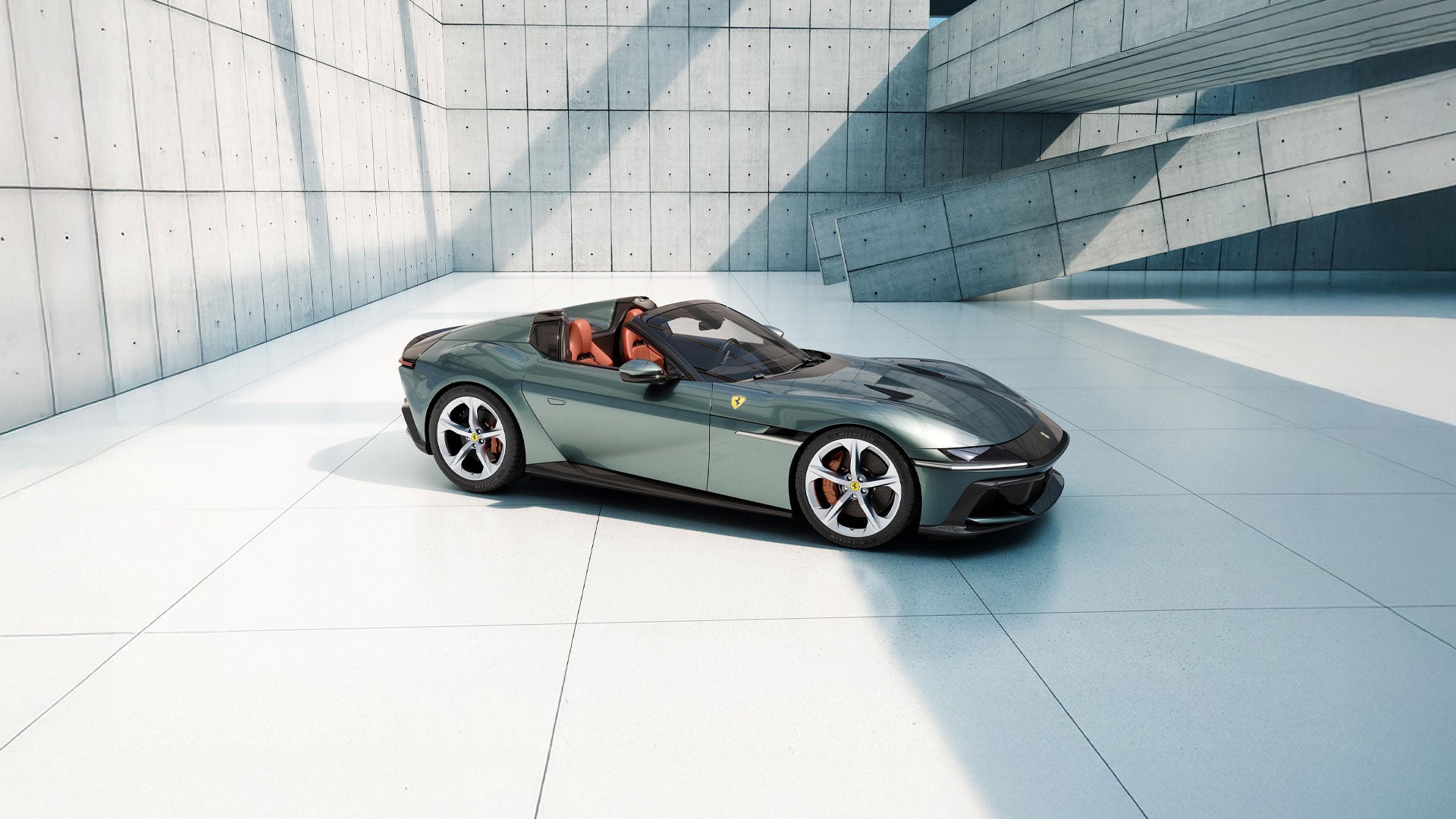 A sleek, dark green Ferrari convertible with orange interior sits on a white tiled floor in a modern concrete structure.