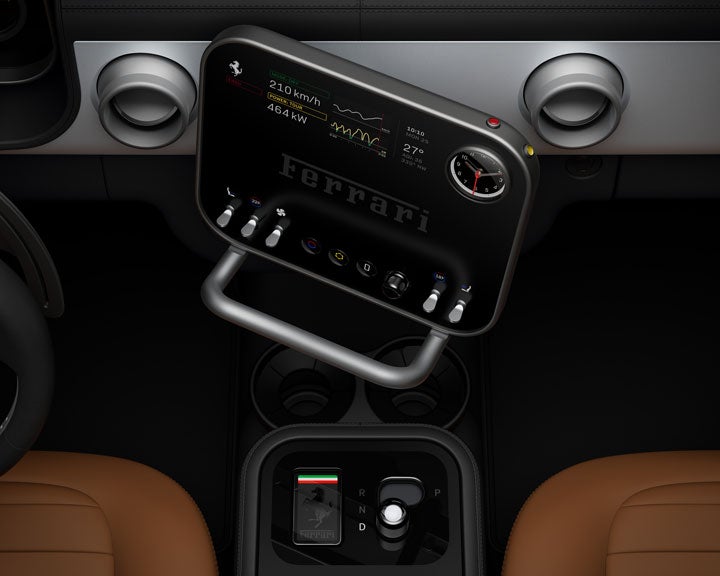 Ferrari dashboard featuring a large, angled black touchscreen display above a smaller gear selector panel.